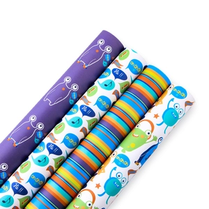 Assorted cartoon gift wrapping paper rolls with stripes and monster patterns for kids
