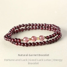 Detail of garnet beaded bracelet featuring pink gemstone accents and golden spacers