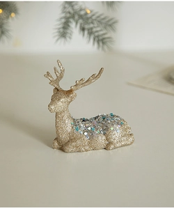 Close-up of golden reindeer ornament with frosted texture and blue sequins detail