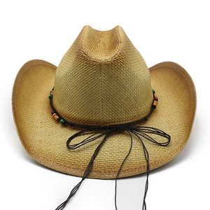 Detail of khaki straw cowboy hat featuring ethnic style colored beads and black rope bow