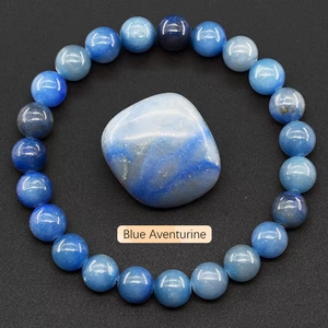 Detailed view of blue aventurine beaded bracelet with a raw matte stone on textured surface