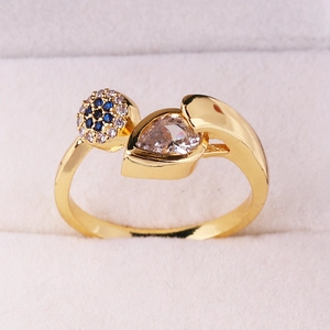 Detailed macro view of 18K gold ring with blue zircon clusters and pear-cut stone