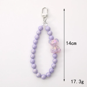Colorful purple beaded keychain with a translucent bear pendant and silver metal clip