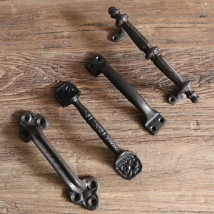 Set of four industrial vintage cast iron door handles with rustic textured finish on wood