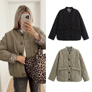 Close-up of olive and black quilted jackets with ribbed collar and leopard print lining detail