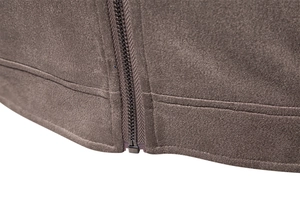 Macro shot of high-quality zipper and suede fabric texture on dark brown jacket