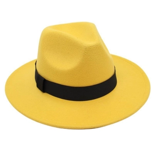 Detailed macro view of yellow wool fedora hat featuring a classic black ribbon band