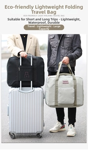 Foldable oxford travel bag showing trolley sleeve attachment for suitcase convenience