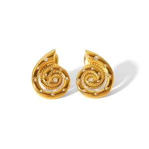 Detailed view of gold snail shell earrings with sparkling crystal rhinestones on white