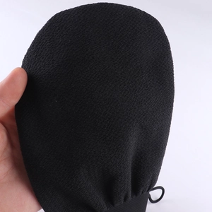 Close-up of the black exfoliating bath glove showing detailed scrubbing texture