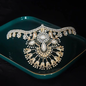 Detailed macro view of luxury gold crown with white pearls and sparkling rhinestones