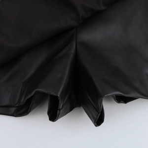 Women's black PU leather high-waisted shorts with side slit design and soft texture