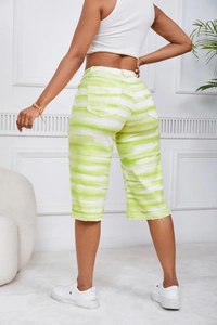 Detail showing the back pockets of lime green tie-dye denim mid-thigh shorts for women