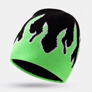 Knit beanie with neon green flame pattern on black background in a stylish side view