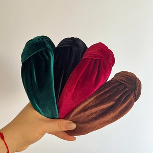 Detail of knot velvet headbands in dark green, black, wine red and caramel colors