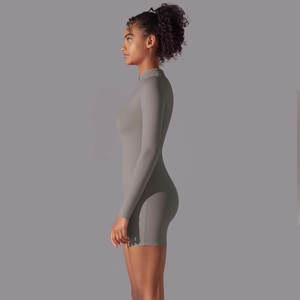 Detail of taupe long sleeve turtleneck jumpsuit with zipper and slim fit athletic cut