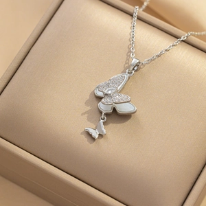 Silver butterfly necklace with white mother-of-pearl wings and sparkling crystals