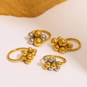 18K gold plated stainless steel grape cluster rings in gold and silver mix on cream background