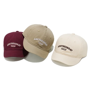 Detailed close-up of cotton baseball caps with high-quality 3D letter embroidery