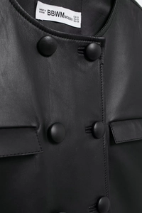 Close-up of black faux leather jacket collar with button details and fine stitching texture