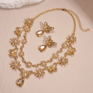 Detailed close-up of double-layer necklace with golden butterfly and amber crystal drops