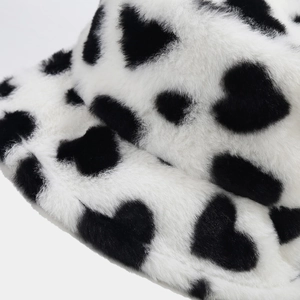 Macro shot of plush fuzzy bucket hat with heart pattern texture and sewing detail