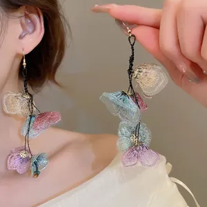 Elegant long floral tassel earrings featuring translucent mesh petals and golden hooks