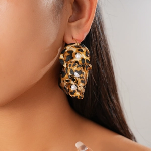 Retro leopard print fabric flower earrings with pearls shown on model ear for women