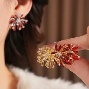 Luxury gold flower fireworks earrings with red enamel petals and cubic zirconia stones