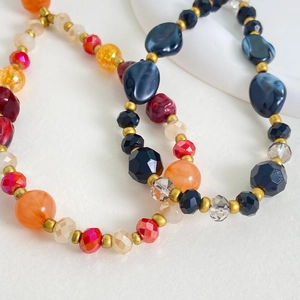 Macro shot of colorful beaded phone straps with glass, acrylic, and metallic beads
