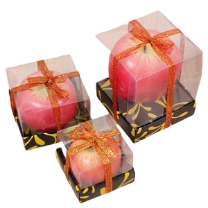 Realistic red apple candles in decorative gift boxes with ribbon for Christmas gift