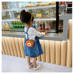 Detailed shot of an orange cartoon duck crossbody bag for kids with metal chain strap