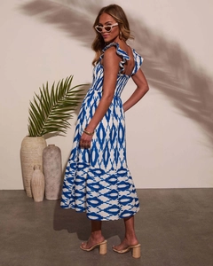 Detailed view of blue and white geometric print dress with ruffled straps and smocked waist