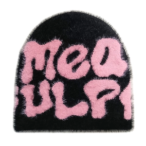 Close-up of black fuzzy knit beanie with pink mea culpa lettering and plush texture