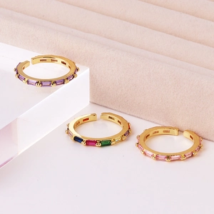 Adjustable gold plated rings featuring rectangular purple, pink and iridescent zircons
