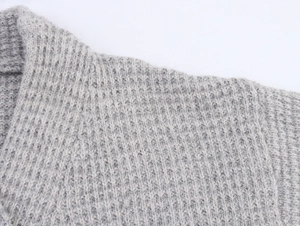 Macro detail of grey cashmere v-neck cardigan showing textured waffle knit pattern