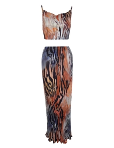 Detail view of plissé fabric texture and abstract print on two-piece maxi skirt set
