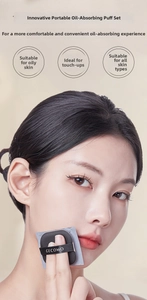 Close-up of bamboo charcoal oil absorbing sheets with puff for oily skin touch-ups