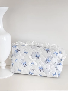 Detail of heart quilting and delicate lace trim on blue cat pattern storage bag