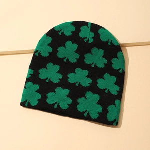 Winter knitted beanie in black with green clover pattern for warmth and style
