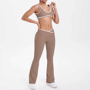 Detail of mocha two-piece yoga set with white trim and crossover high-waisted flared pants
