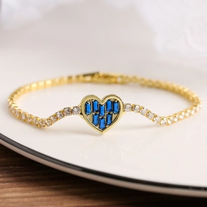 Elegant gold heart bracelet with blue rectangular gemstones and white zircon accents