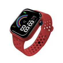 Detail of red silicone wristband and LED touch screen displaying fitness tracking data