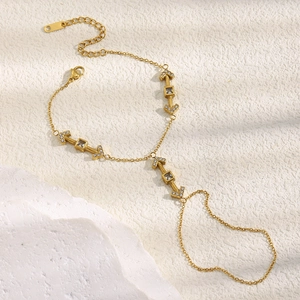 Detail of 18K gold-plated arrow hand chain featuring sparkling square zircon inlays