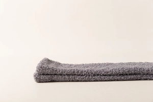 Close-up of soft grey coral fleece texture on thick winter knee-high socks