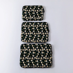 Three-piece black laptop sleeve set with white daisy embroidery in different sizes