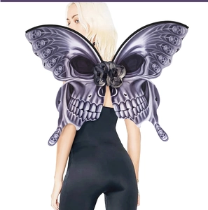 Detail view of gothic butterfly wings featuring skull patterns and black silk flower decor