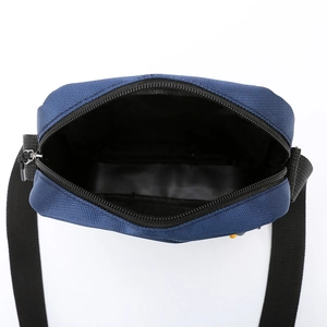 Top view of dark blue nylon crossbody bag showing interior structure and zipper details