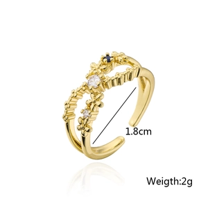 Detail showing 1.8cm diameter of a gold flower ring with blue and white zircons