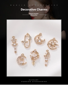 Macro view of gold-plated star and moon charms with sparkling cubic zirconia inlays